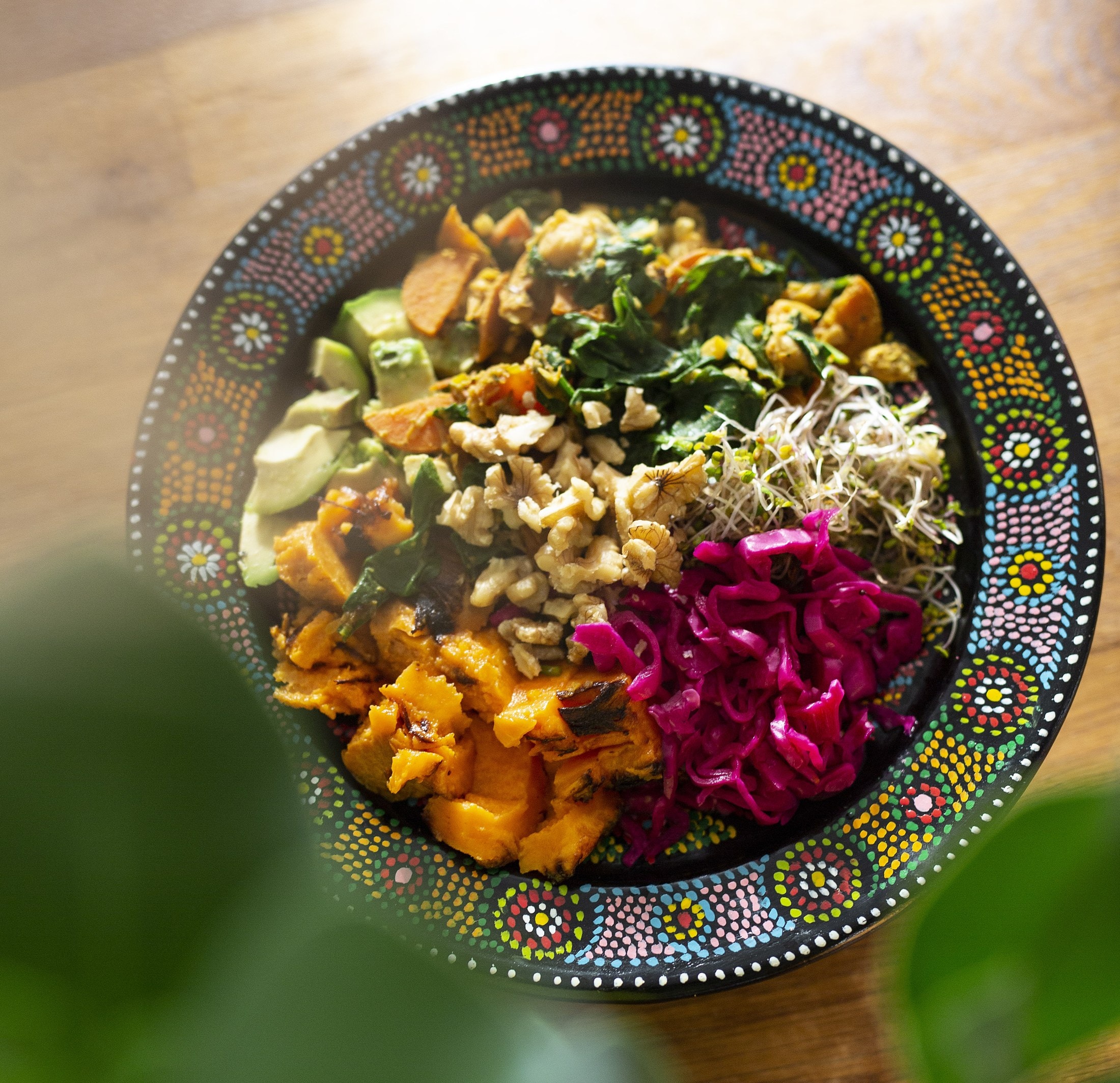 A colourful bowl of roasted vegetables, walnuts and pickled cabbage