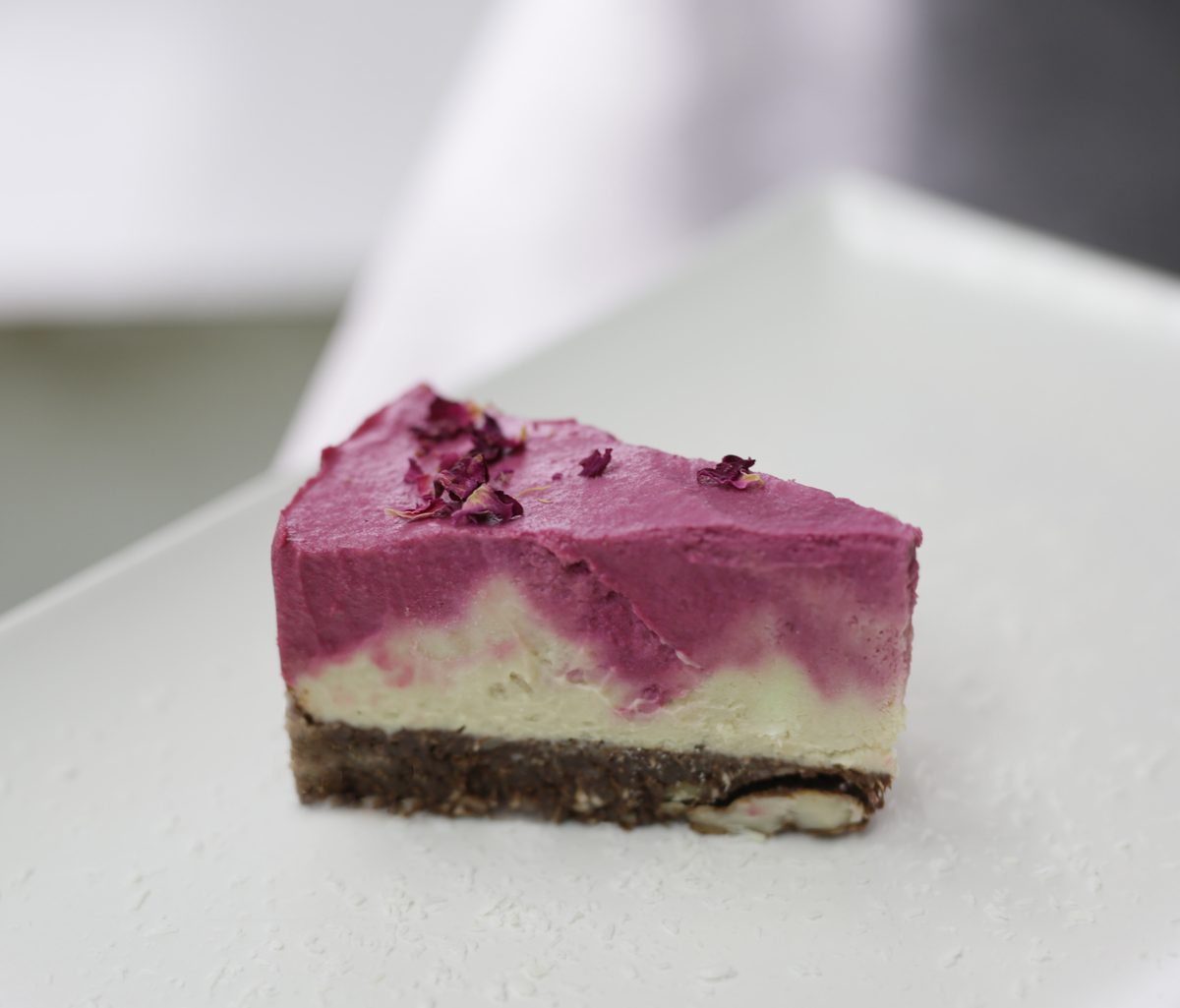 A slice of raw berry cheesecake